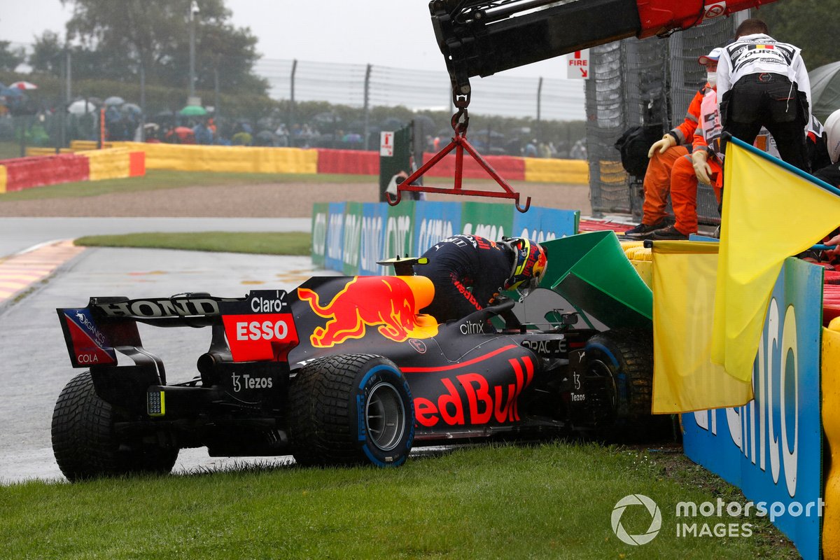 Sergio Perez, Red Bull Racing RB16B, climbs out of his car after crashing on the way to the grid