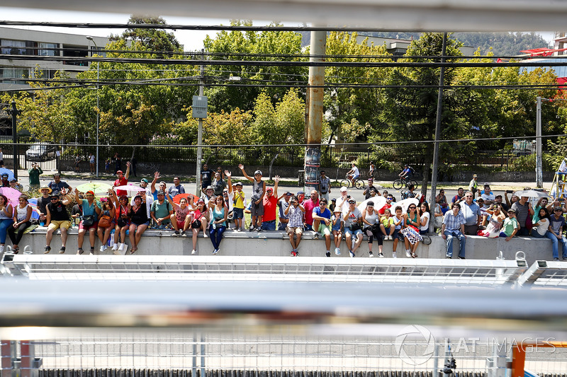 Fans wave at the drivers