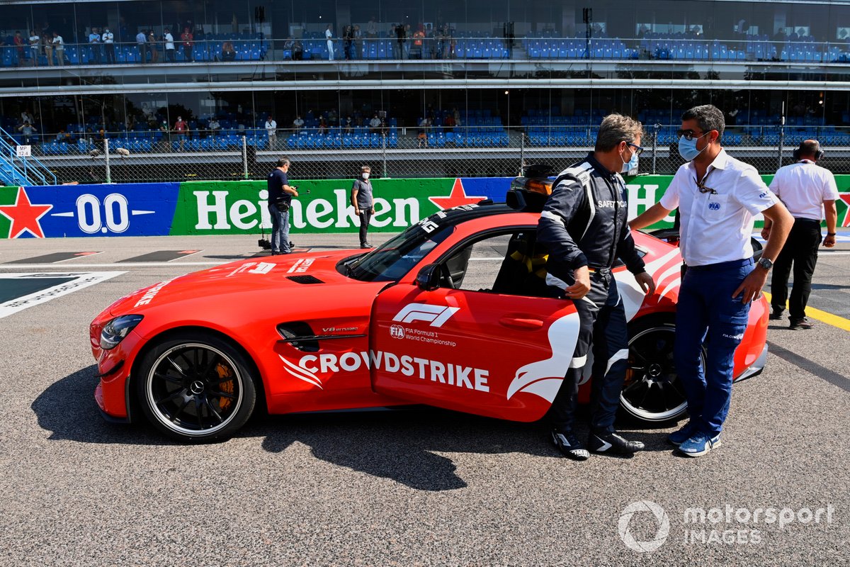 Bernd Maylander, Safety Car Driver, and the Safety Car on the grid with Michael Masi, Race Director, FIA