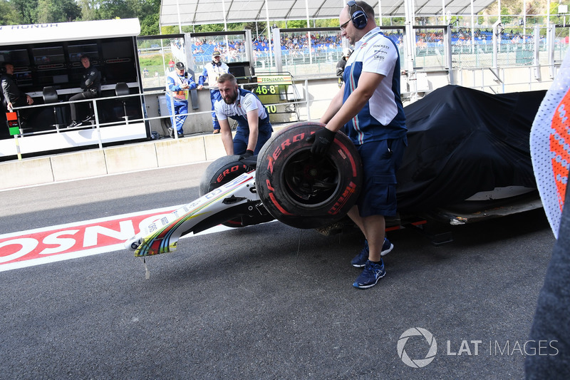 The crashed car of Felipe Massa, Williams FW40 is recovered in FP1 and pushed down pitlane by mechanics