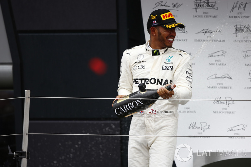 Race winner Lewis Hamilton, Mercedes AMG F1, celebrates with champagne on the podium