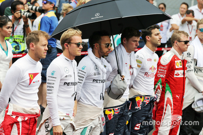 The drivers as the grid observes the national anthem