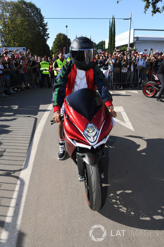 Lewis Hamilton, Mercedes AMG F1 arrives at the track on his motorbike