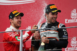 (L to R): Sebastian Vettel, Ferrari celebrates his second position on the podium with third placed S