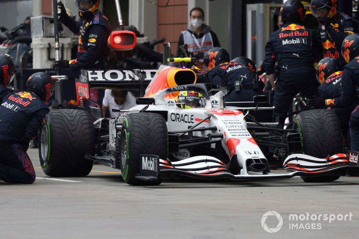 Sergio Perez, Red Bull Racing RB16B, leaves his pit box after a stop