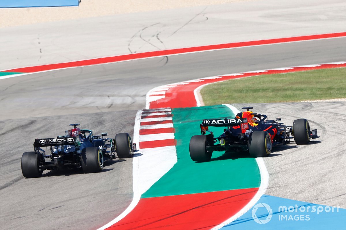 Lewis Hamilton, Mercedes W12, passes as Max Verstappen, Red Bull Racing RB16B, runs wide