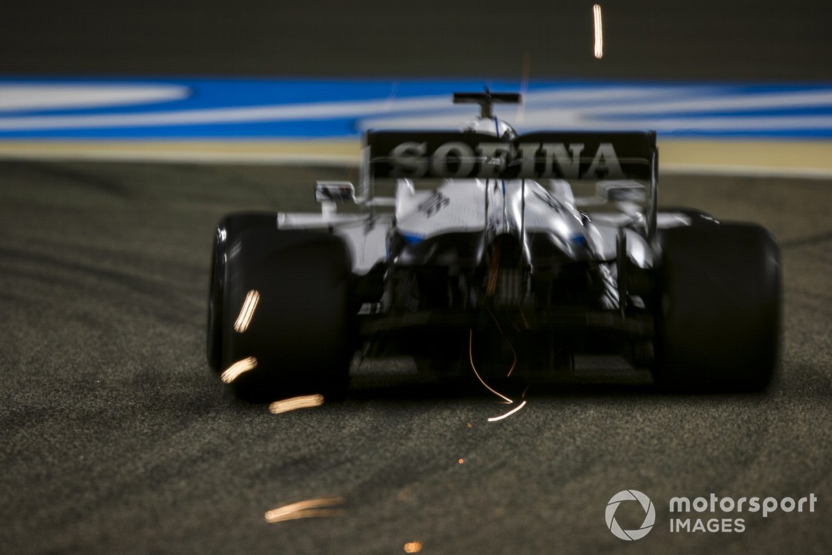 Sparks fly from the rear of George Russell, Williams FW43