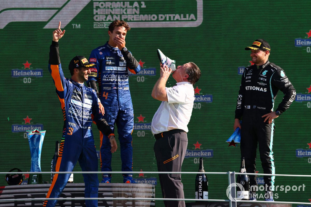 Daniel Ricciardo, McLaren, 1st position, Lando Norris, McLaren, 2nd position, and Zak Brown, CEO, McLaren Racing, celebrate on the podium with shoeys