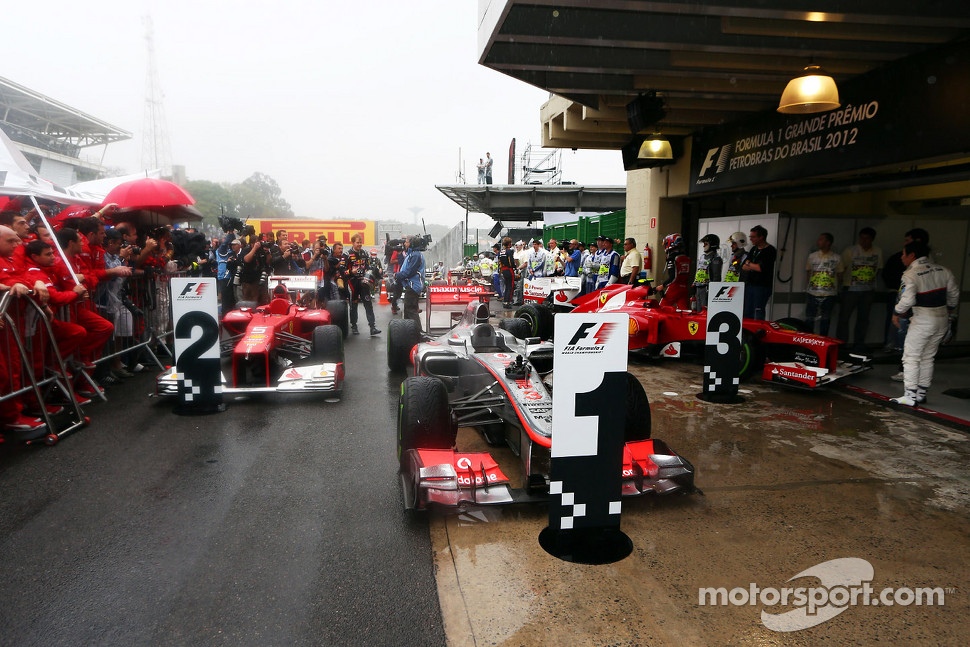 The cars in parc ferme, Fernando Alonso, Ferrari, second; Jenson Button, McLaren, race winner; Felipe Massa, Ferrari, third