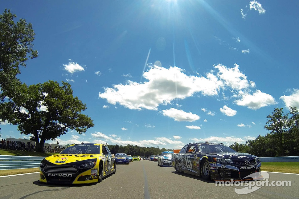 Polesitter Marcos Ambrose and Clint Bowyer follow the safety car during pace laps