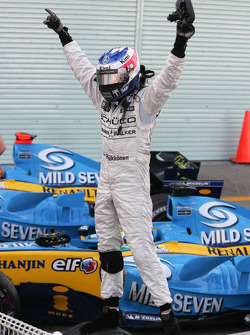 Race winner Kimi Raikkonen celebrates