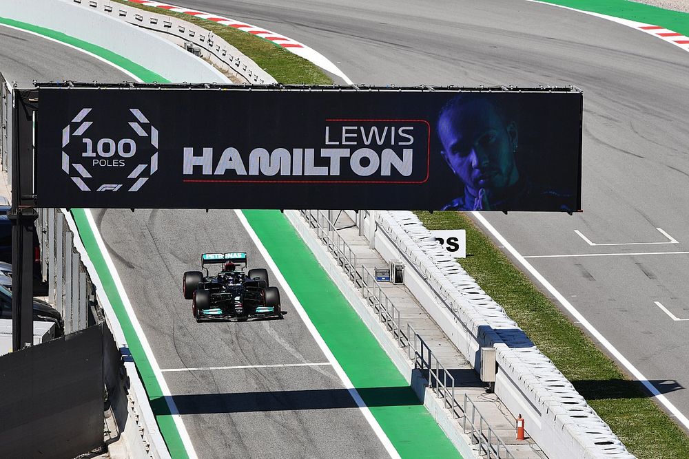 Lewis Hamilton, Mercedes W12, drives into Parc Ferme after securing his 100th pole position in F1