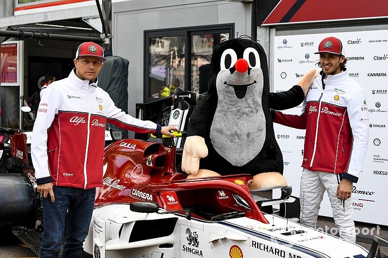 Kimi Raikkonen, Alfa Romeo Racing and Antonio Giovinazzi, Alfa Romeo Racing pose for a photograph with a mole