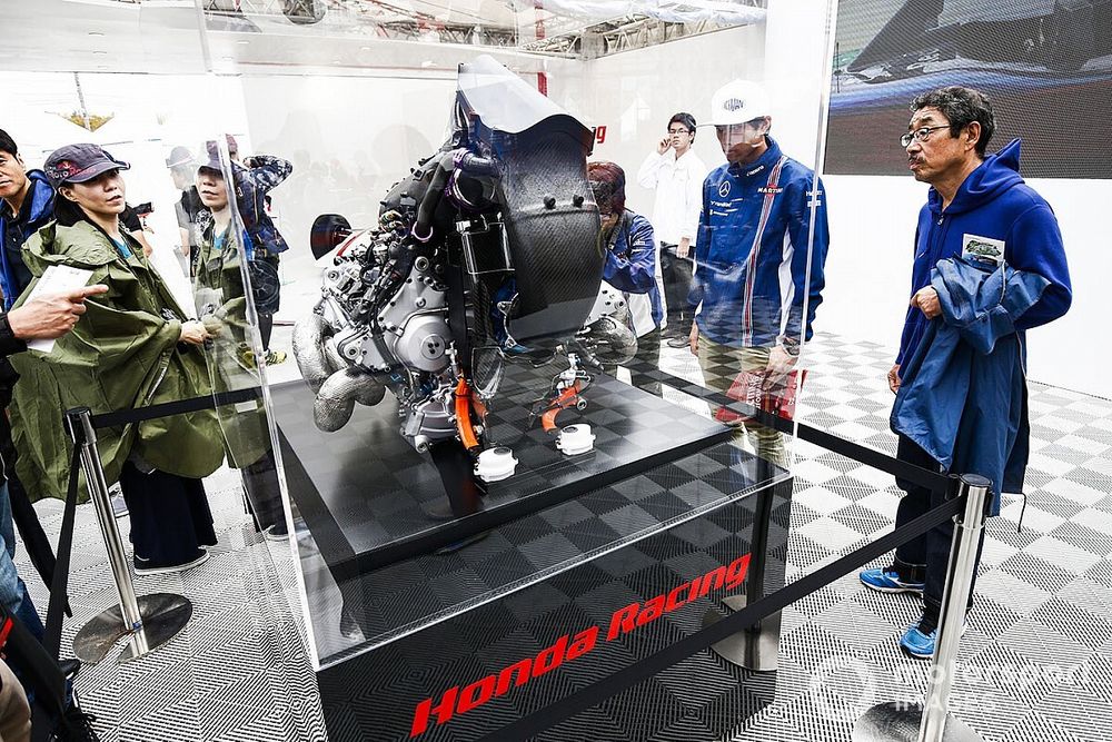 Fans admire a Honda F1 power unit