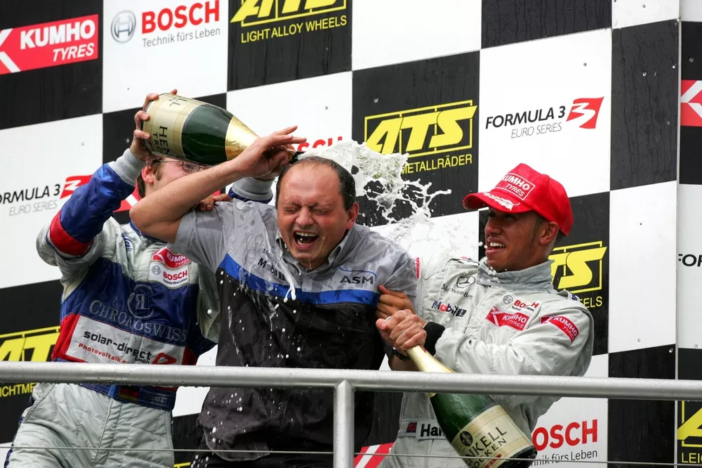 An ASM mechanic getting a champagne shower from Maximilian Gotz (GER), ASM Formule 3, Dallara F305 Mercedes (3rd, left) and Lewis Hamilton (GBR), ASM Formule 3, Dallara F305 Mercedes (1st, right). 
Formula Three Euroseries, Rd19, Hockenheim, Germany. 22 October 2005.
DIGITAL IMAGE