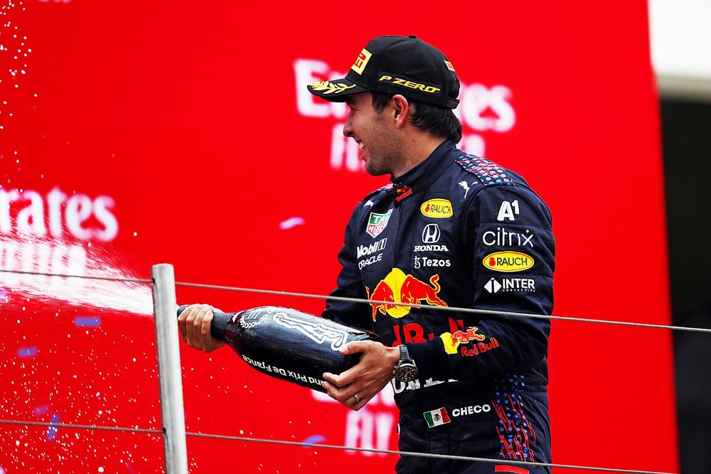 Sergio Perez, Red Bull Racing, 3rd position, sprays Champagne on the podium