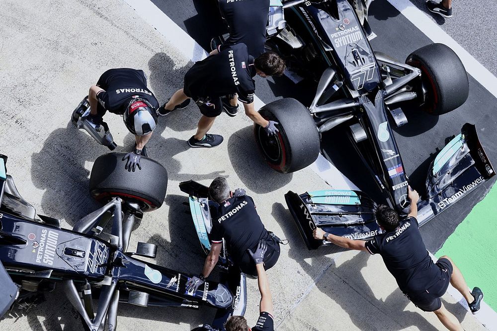 Mechanics move the cars of Valtteri Bottas, Mercedes W12, and Lewis Hamilton, Mercedes W12, in the pits lane