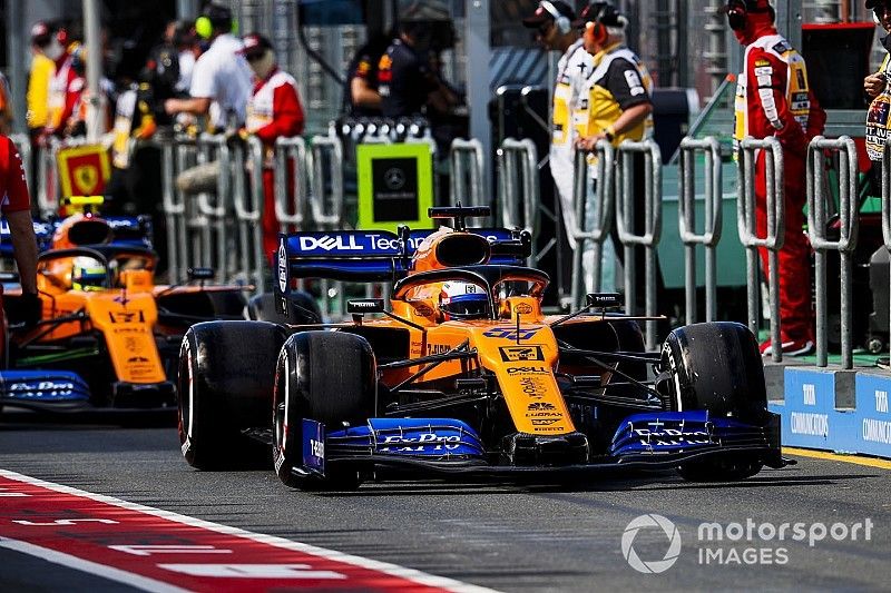 Carlos Sainz Jr., McLaren MCL34, leads Lando Norris, McLaren MCL34, in the pit lane