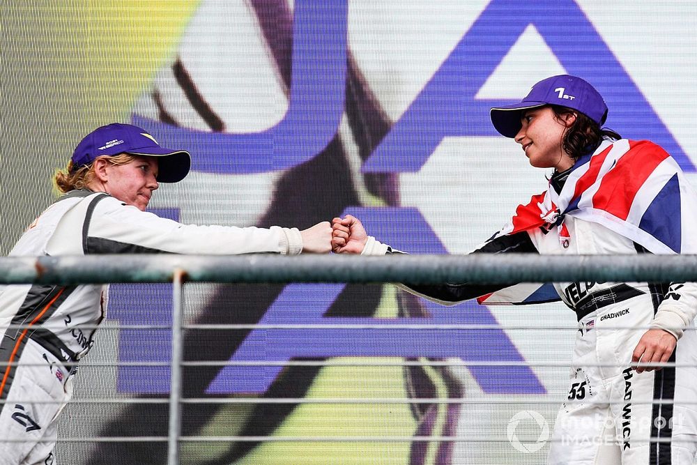 Champion Jamie Chadwick is congratulated by Alice Powell on the podium