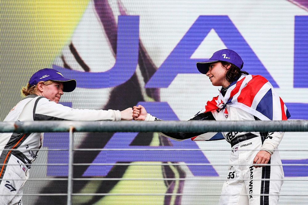 Champion Jamie Chadwick is congratulated by Alice Powell on the podium