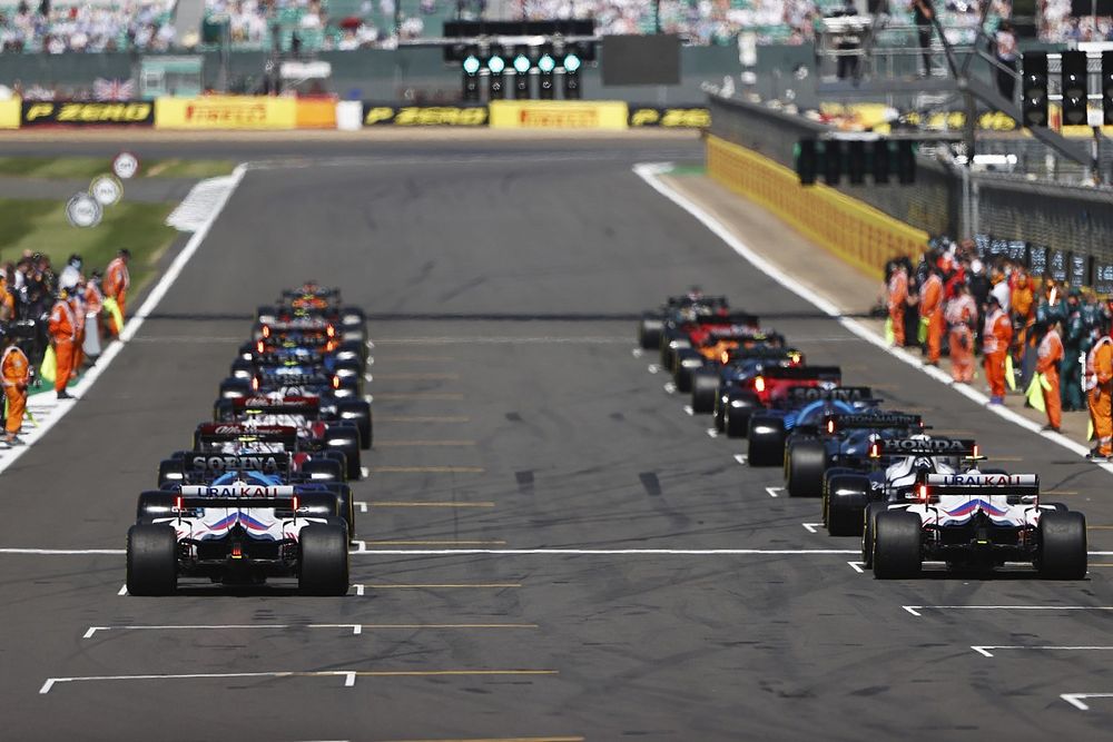 Max Verstappen, Red Bull Racing RB16B, and Lewis Hamilton, Mercedes W12, lead the field away as the lights go green