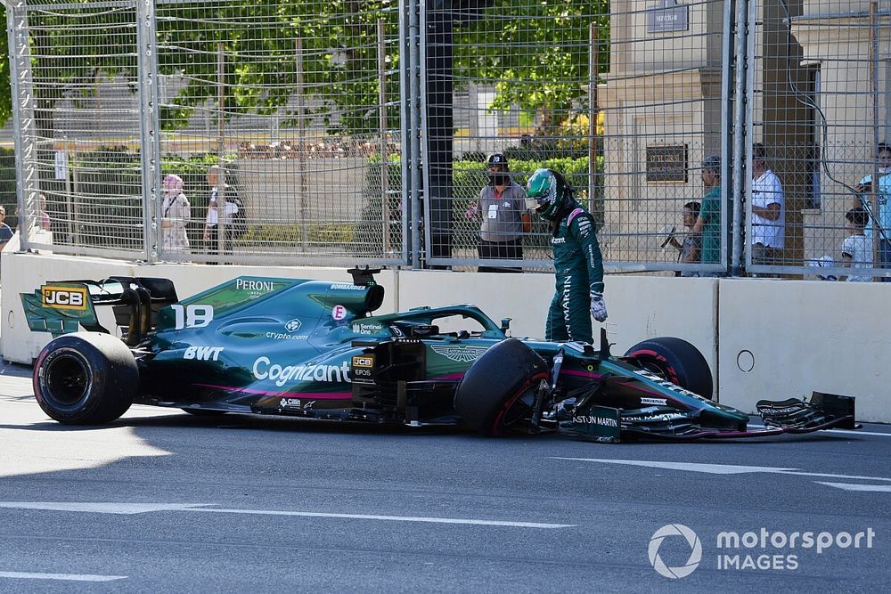 Lance Stroll, Aston Martin AMR21, walks away from his car after hitting the wall