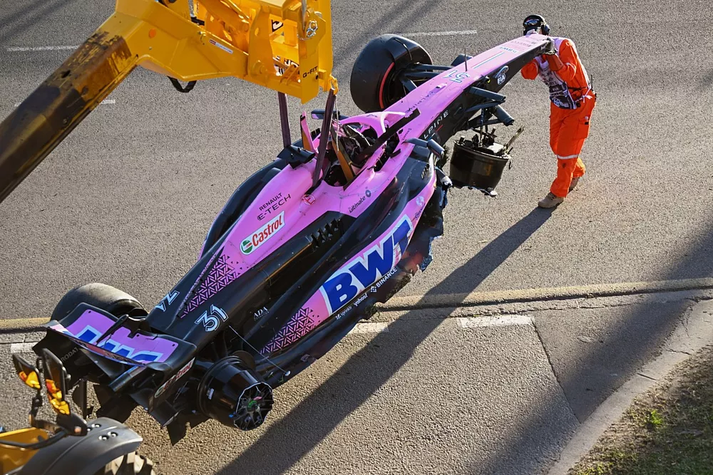 Marshals remove the damaged car of Esteban Ocon, Alpine A523, from the circuit after the race