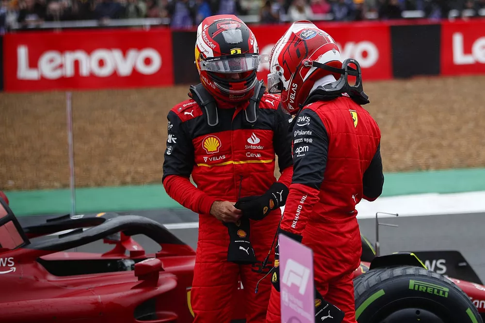Charles Leclerc, Ferrari, talks with pole man Carlos Sainz, Ferrari, on the grid