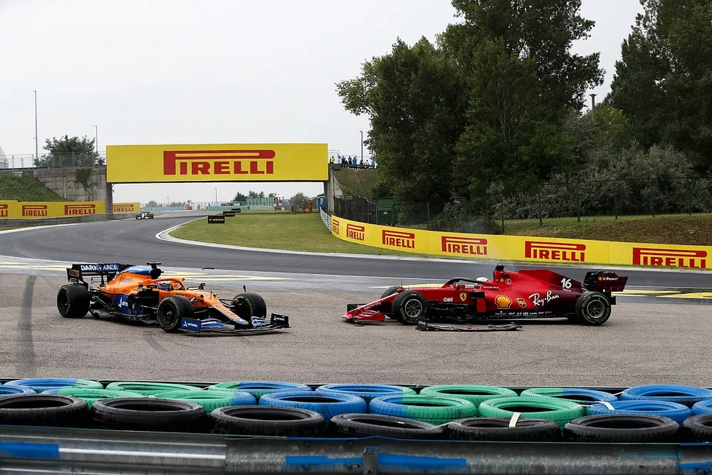 Daniel Ricciardo, McLaren MCL35M, and Charles Leclerc, Ferrari SF21, off the circuit after a crash on the opening lap