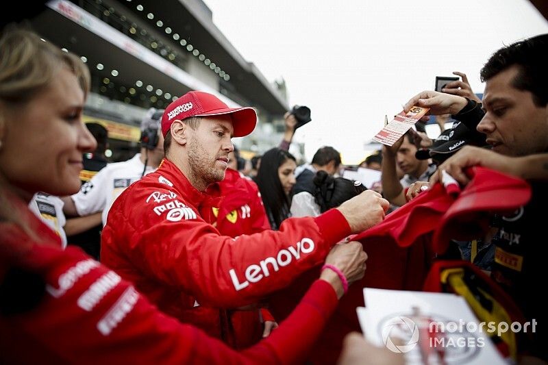 Sebastian Vettel, Ferrari signs an autograph for a fan 