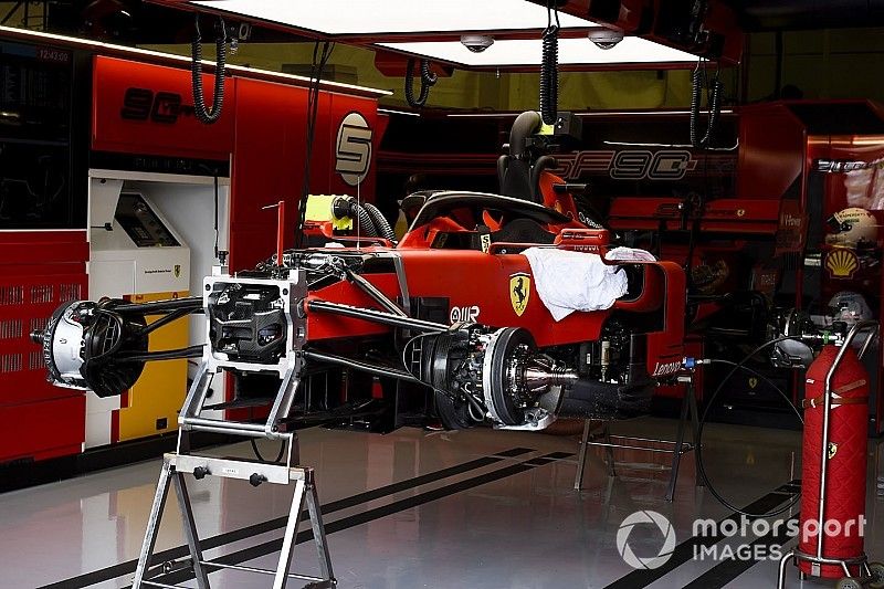 The car of Sebastian Vettel, Ferrari SF90, half built in the garage