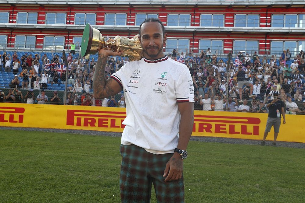 Race winner Lewis Hamilton, Mercedes, celebrates after the race with his trophy