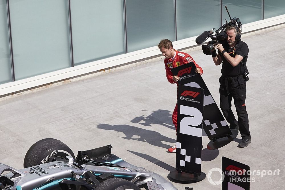 Sebastian Vettel, Ferrari, 2nd position, switches the position boards in protest of a penalty that cost him victory