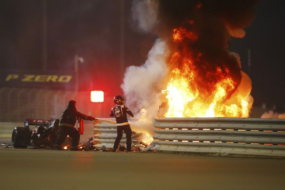 The wreckage of the Romain Grosjean Haas VF-20 after a horrific accident on the opening lap of the Bahrtain Grand Prix. The car punctured a hole through the armco barrier and exploded into flames, Marshals attend the fire