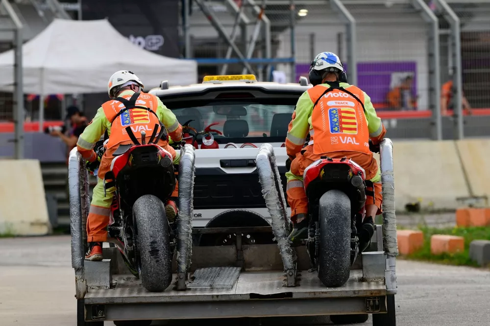Both HRC Castrol Honda's are taken back to the garages after crashing o during the Sprint