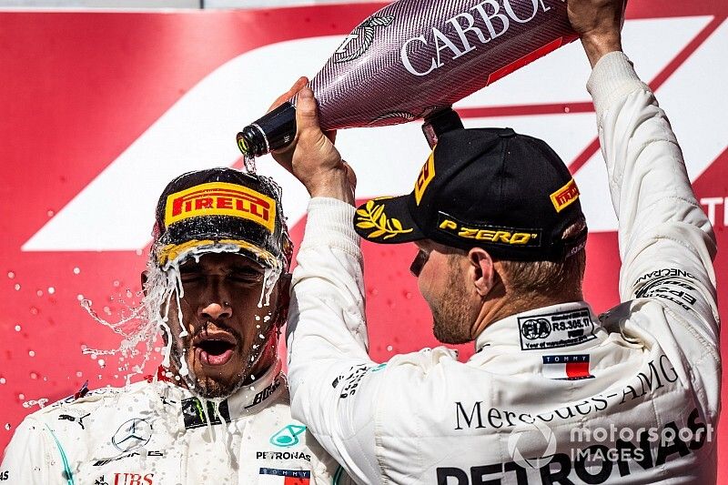 Valtteri Bottas, Mercedes AMG F1, 1st position, pours Champagne over the head of Lewis Hamilton, Mercedes AMG F1, 2nd position, on the podium