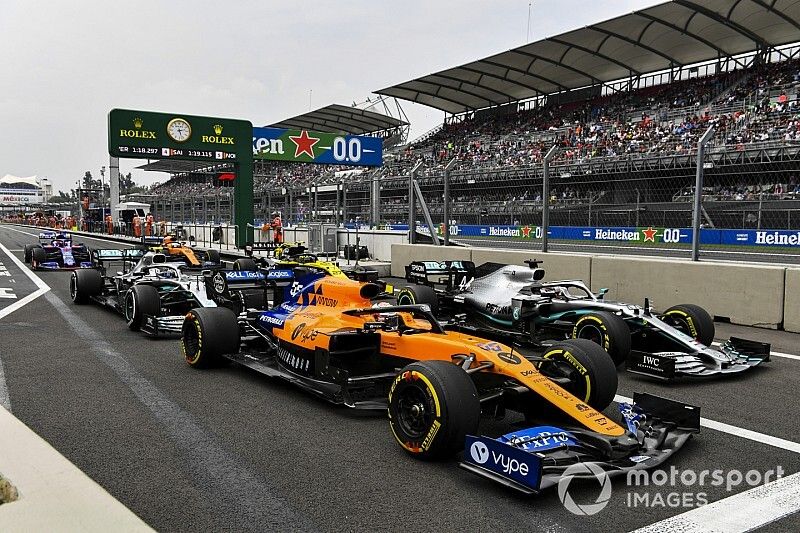 Carlos Sainz Jr., McLaren MCL34, Lewis Hamilton, Mercedes AMG F1 W10, Valtteri Bottas, Mercedes AMG W10, Nico Hulkenberg, Renault F1 Team R.S. 19, Daniil Kvyat, Toro Rosso STR14, and Lando Norris, McLaren MCL34, queue to leave the pits