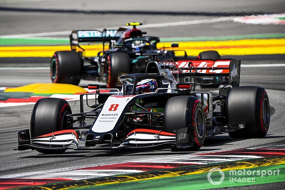 Romain Grosjean, Haas VF-20, leads Valtteri Bottas, Mercedes F1 W11 EQ Performance