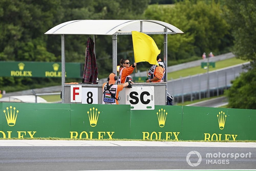 A marshal waves a yellow flag