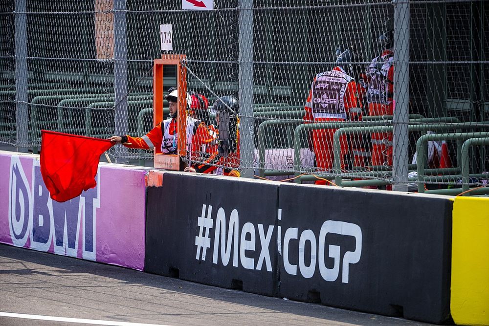 A marshal waves the red flag