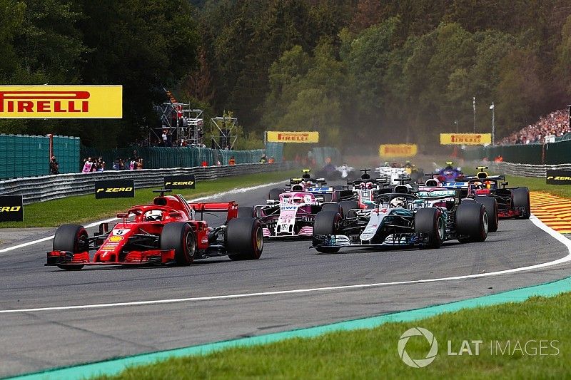 Sebastian Vettel, Ferrari SF71H, leads Lewis Hamilton, Mercedes AMG F1 W09, Esteban Ocon, Racing Point Force India VJM11, and Sergio Perez, Racing Point Force India VJM11, on the opening lap