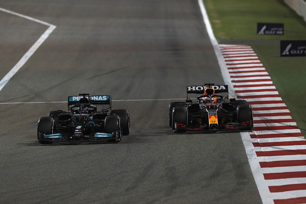 Lewis Hamilton, Mercedes W12, passes Max Verstappen, Red Bull Racing RB16B