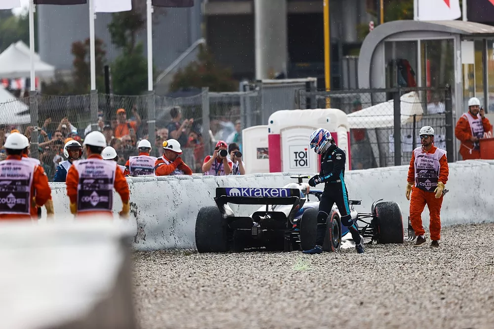 Marshals assist Logan Sargeant, Williams Racing, after a crash in FP3