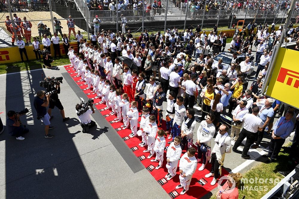 The drivers line up for the national anthem prior to the start