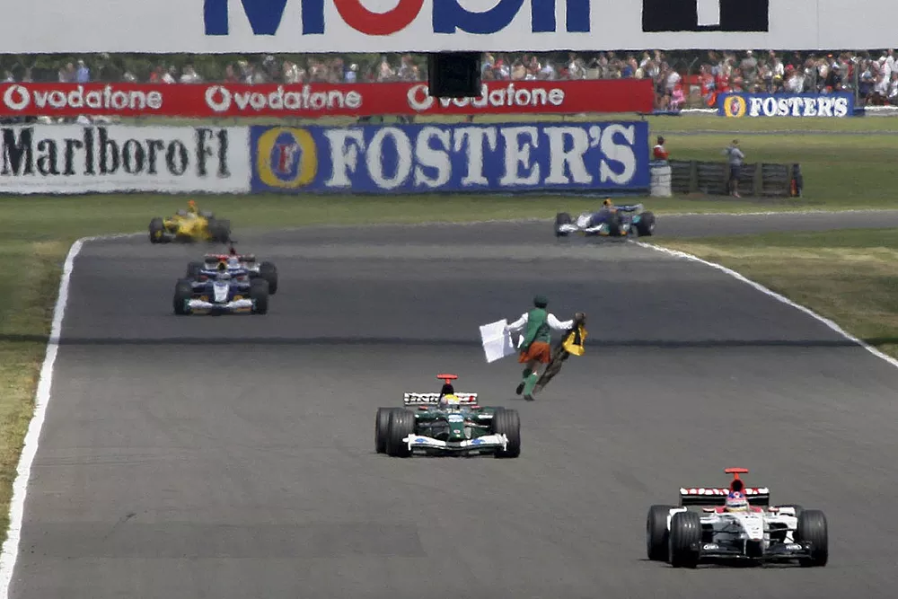 Track invasion by religious activist and former priest Neil Horan. The safety car was deployed and Horan was arrested for aggrevated trespass. Mark Webber, Jaguar, Jacques Villeneuve, BAR seen in action.
