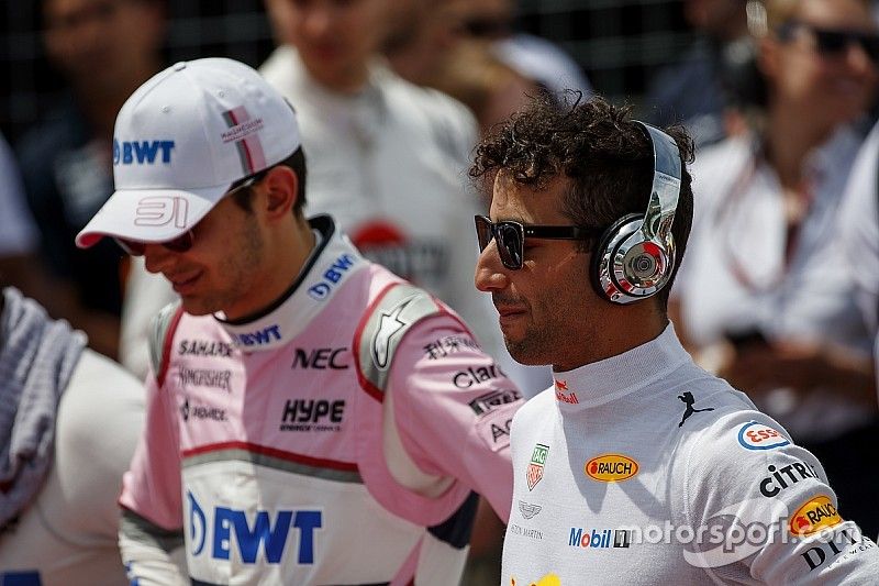 Esteban Ocon, Force India, and Daniel Ricciardo, Red Bull Racing, stand for the national anthem on the grid