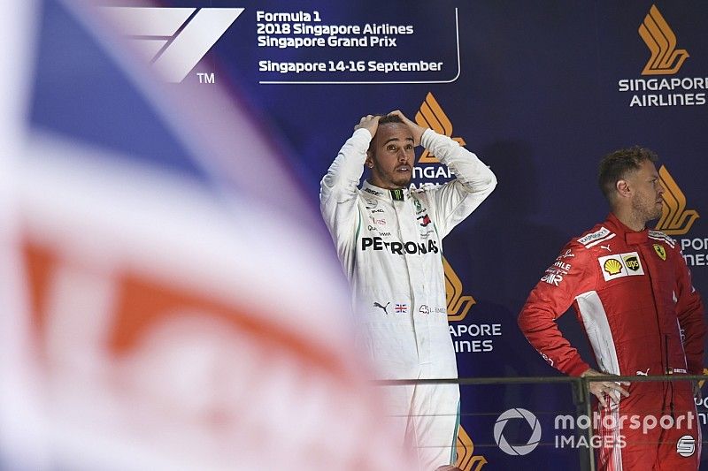 (L to R): Lewis Hamilton, Mercedes AMG F1 and Sebastian Vettel, Ferrari celebrate on the podium 