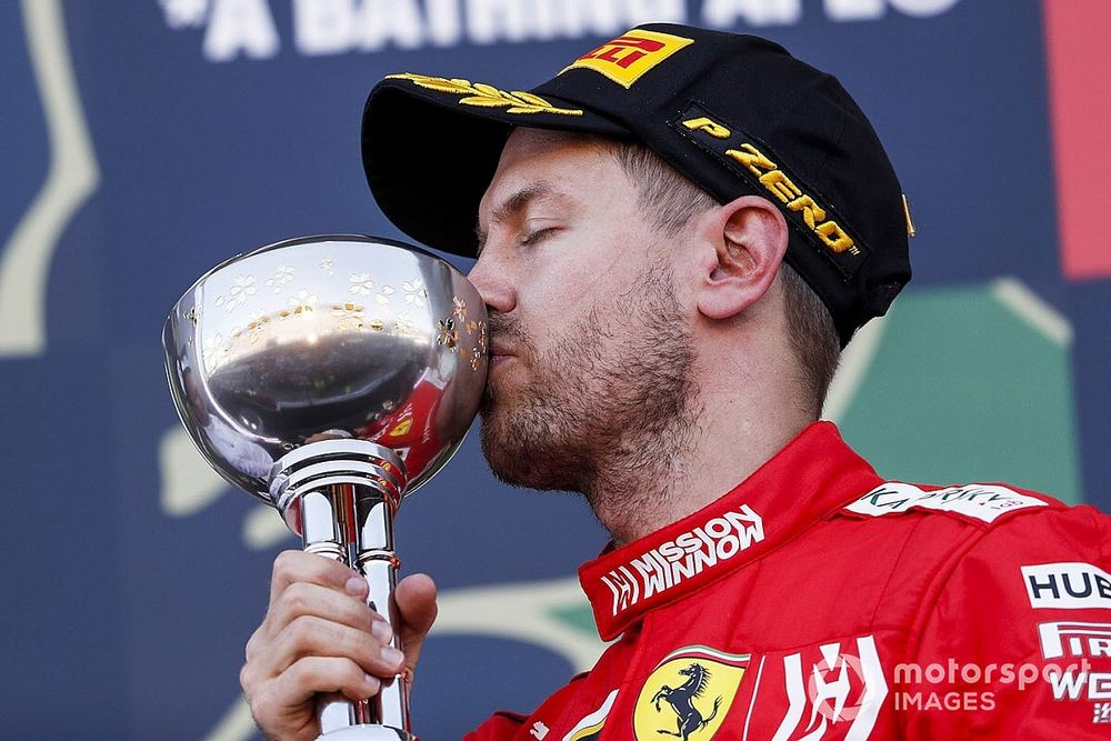 Sebastian Vettel, Ferrari celebrates on the podium with the trophy