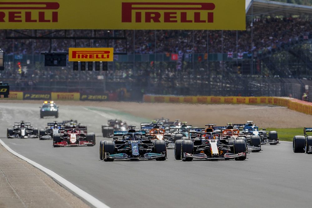 Max Verstappen, Red Bull Racing RB16B, and Lewis Hamilton, Mercedes W12, lead the field away at the start