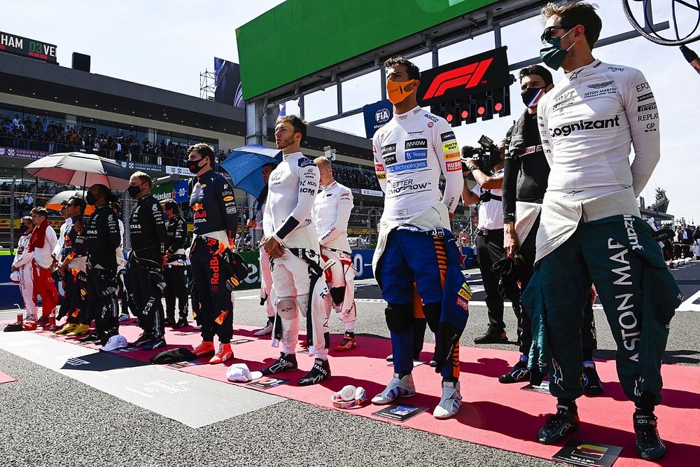 Max Verstappen, Red Bull Racing, Pierre Gasly, AlphaTauri, Daniel Ricciardo, McLaren, Sebastian Vettel, Aston Martin, and the other drivers stand for the national anthem prior to the start